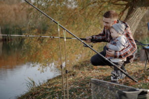 Father and baby stream fishing