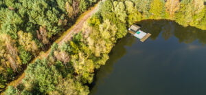 fishing lodge in the corner of a pond aerial view