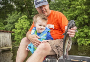 son and dad caught fish in the boat